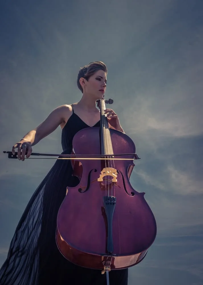 Carly Fleming playing cello by the ocean