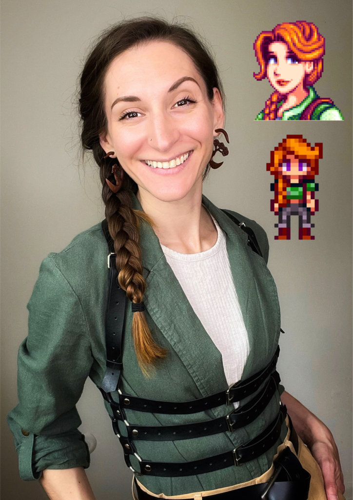 Bri is wearing a cream undershirt, olive green blazer, and black harness tucked into high waisted brown trousers. Her hair is braided on one side similar to the Stardew Valley video game character, Leah. Two images of Leah are included in the corner to compare the outfit example with. 