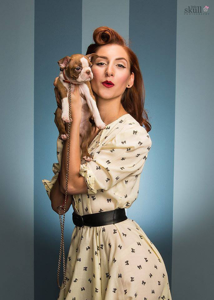Bri embraces the Cozy Caretaker Matriarch style with a vintage yellow dress with black bows and a black belt that belonged to her own mother! A pin-up styled outfit has Bri showcasing victory roll curls, a retro red lip, and embodying her inner dog-mom by holding the photographer's puppy, Stella, making this image heartwarming and full of motherly love!